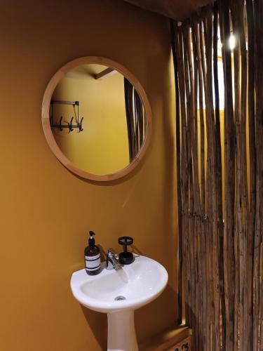 a bathroom with a sink and a mirror at Kite Eco House Salinas del rey in Salina de Rey