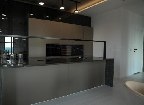 a kitchen with black and white cabinets and a sink at PREMIUM Apartment in center of Katowice in Katowice