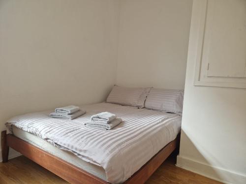 a bed with two towels on top of it at Suite 2: Chic Room near City Centre in Sheffield