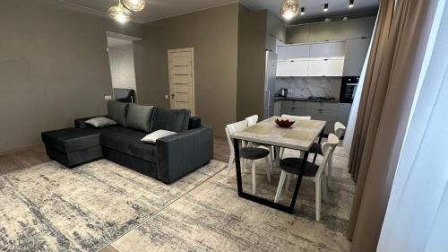 a living room with a couch and a dining room table at Apartment in center of Chisinau in Chişinău