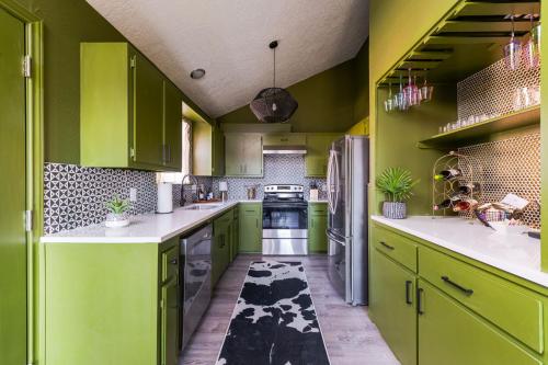 a green kitchen with green cabinets and white counter tops at Minutes To Ou Stadium Fire Pit Grill 3bd in Norman