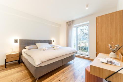 a bedroom with a bed with two stuffed animals on it at Apartments Villa Julia in Lana