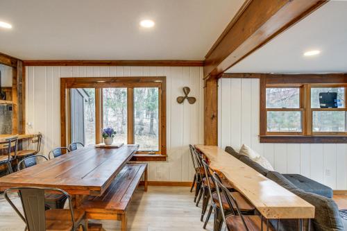 a dining room with a large wooden table and chairs at Waterfront Duluth Cabin with Deck and River View! in Duluth