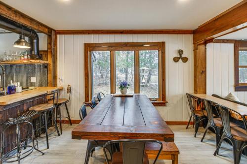 a dining room with a wooden table and chairs at Waterfront Duluth Cabin with Deck and River View! in Duluth