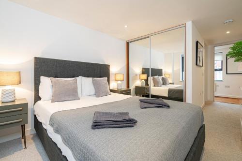 a bedroom with a large bed with a large mirror at Stay at Whitfield Street in London