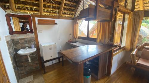 a small bathroom with a sink and a mirror at Zutalu - Playa Sur in Puerto López