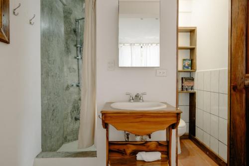 a bathroom with a sink and a shower at Ocean view studio in Pelada! in Nosara