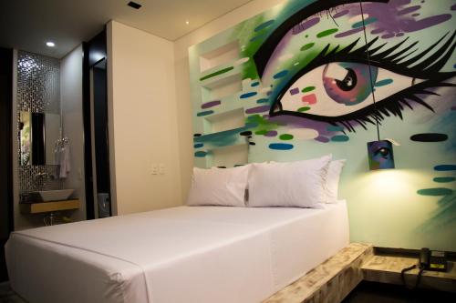 Una cama o camas en una habitación de Hotel Medellin Arte