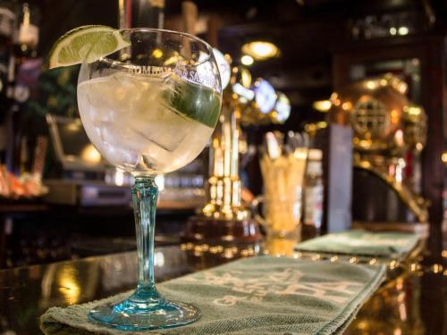 a glass with a lime in it sitting on a bar at The Ship in Chelmsford