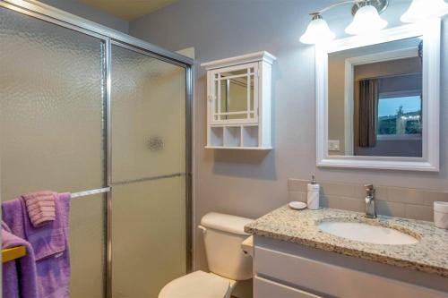 a bathroom with a toilet and a sink and a shower at Riverside Condo located Downtown Enjoy Nightlife in Bend