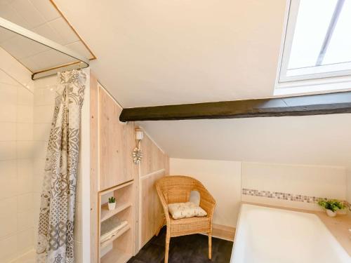 a small attic room with a chair and a window at 4 Bed in Keswick 86392 in Rosthwaite