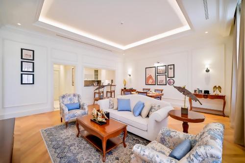 a living room with a couch and chairs and a table at 21 High Street Residence By The Torch in Doha