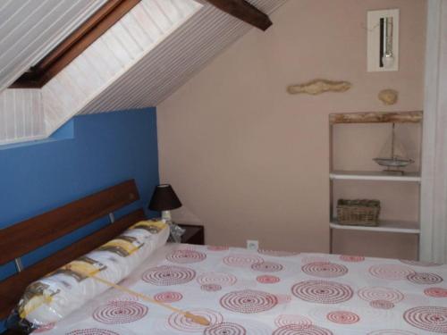 une chambre avec un grand lit avec un mur bleu dans l'établissement Gite Atelier Montignac // Piscine à débordement, à Montignac