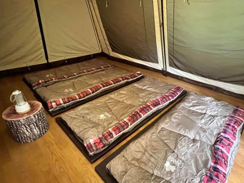 three sleeping bags on the floor of a tent at Nagatoro Camp Village - Vacation STAY 06871v in Minano