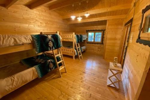 a room with bunk beds in a log cabin at Nagatoro Camp Village - Vacation STAY 06873v in Minano