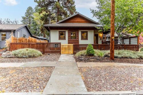 a small house with a wooden fence at Walk to Everything Bikes AC Dog Friendly in Bend