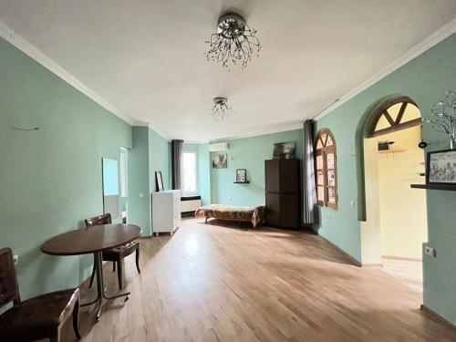 an empty living room with a table and a dining room at center LG Apartment in Tbilisi City