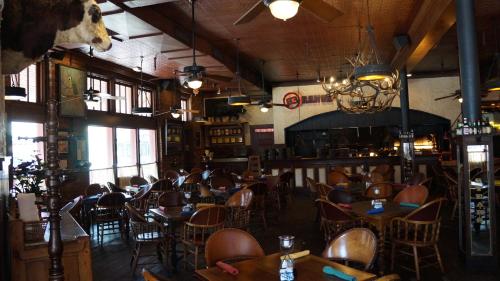 a restaurant with tables and chairs in a room at Stockyards Hotel in Fort Worth