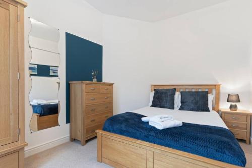 a bedroom with a large bed with a blue blanket at Elton House - Prime Location - Free Parking, Fast WiFi and Smart TV by Yoko Property in Redcar