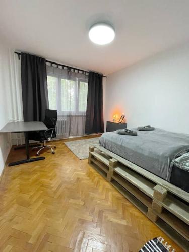 a bedroom with a bed and a desk and a keyboard at Útulný byt blízko centra Košíc in Košice