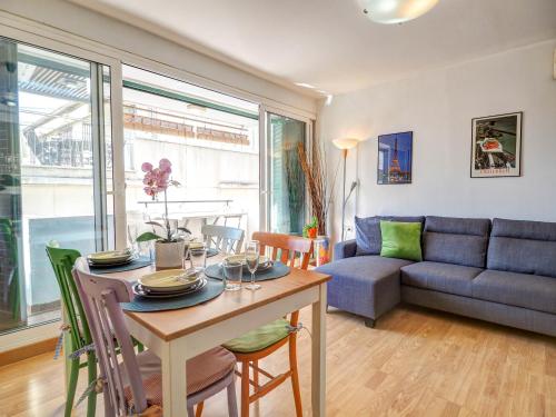 a living room with a table and a couch at Carmen Apartment by Hello Homes Sitges in Sitges