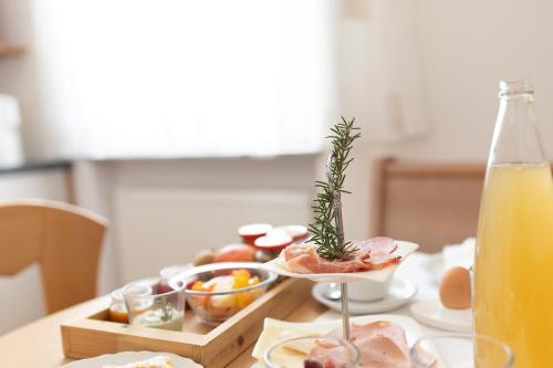 a table with a tray of food and a bottle of orange juice at Residence Walchhof in Schenna