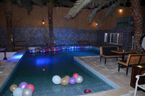a pool with a bunch of balloons in it at منتجع ريف خزيمة - الصباح in Al Madinah