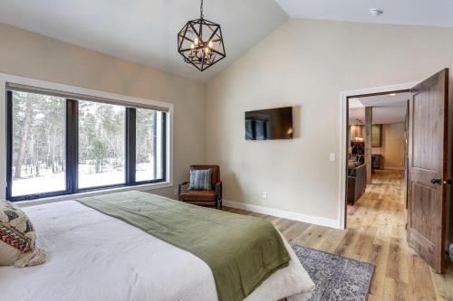 a bedroom with a bed and a large window at The Juniper - Hot tub in Lead
