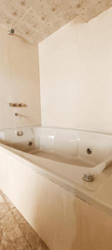 a white bath tub sitting in a room at HGA-Rubí-Spa in La Paz