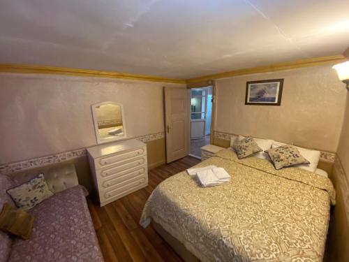 a bedroom with two beds and a dresser and a mirror at DEDENİN YERİ İSTANBUL in Istanbul