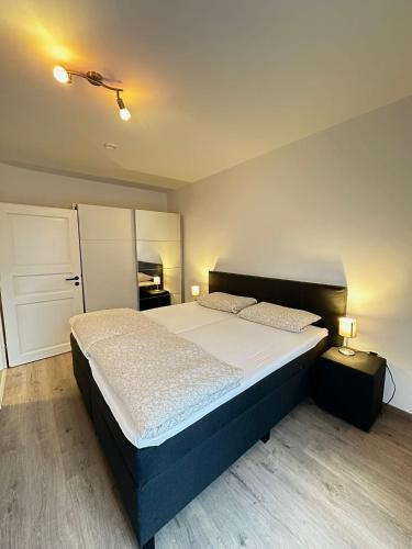 a bedroom with a large bed in a room at KM Apparts Wesel 3 in Wesel