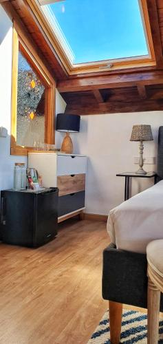 a bedroom with a bed and a skylight at Refugio del Cares in Ortiguero