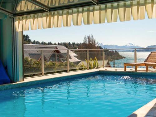 a swimming pool with a view of the water at Quintaluna ski y playa. in San Carlos de Bariloche