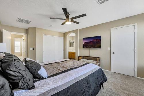 a bedroom with a bed and a ceiling fan at Jill's Goodyear Getaway in Goodyear