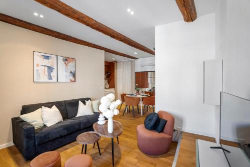 a living room with a couch and a table at Nice Renting - 9b Massena - Chic Escape in the Heart of Nice Comfort & Charm ! in Nice