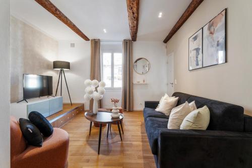 a living room with a couch and a table at Nice Renting - 9b Massena - Chic Escape in the Heart of Nice Comfort & Charm ! in Nice