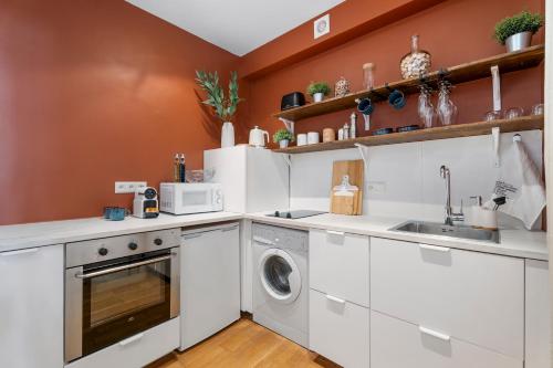 a kitchen with white cabinets and a washer and dryer at Nice Renting - 9b Massena - Chic Escape in the Heart of Nice Comfort & Charm ! in Nice