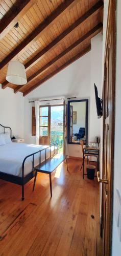 a bedroom with a bed and a large window at Refugio del Cares in Ortiguero