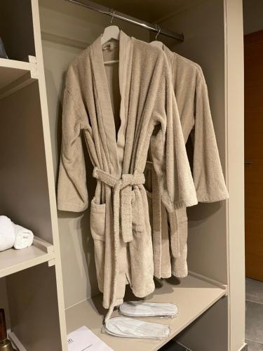 a robe is hanging in a closet at L’Évasion - Chambre & Jacuzzi in Obigies