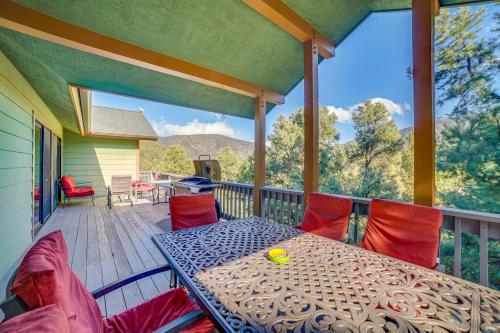 a patio with a table and chairs on a deck at Pine Mountain Club Home with Beautiful View! in Frazier Park