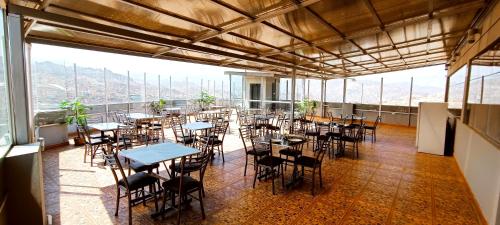 a restaurant with tables and chairs in a room with a view at HGA-Topacio-Spa in La Paz