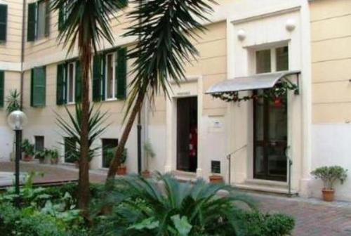 a building with palm trees in front of it at Maestoso Appartamento Turistico in Rome