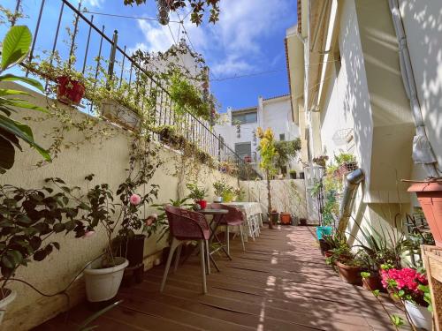 a patio with tables and chairs on a building at nicole's home in Athens