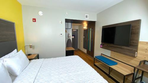 a hotel room with a bed and a flat screen tv at Tru By Hilton Manassas, Va in Manassas