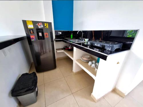 a small kitchen with a refrigerator and a sink at Apartamento Privado Palomino in Palomino