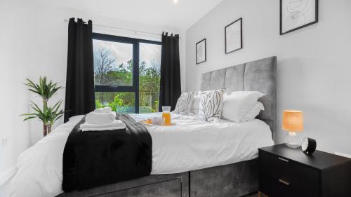 a bedroom with a large bed and a window at Axium Escape- 2 bed apartment, Birmingham City Centre in Birmingham