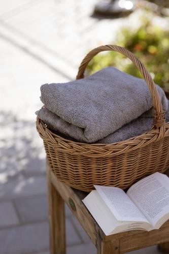 a basket with towels and a book on a table at Residence Walchhof in Schenna