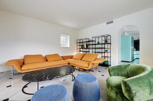 a living room with a couch and two chairs at Design Villa in Tremezzina Villarnona Lake Como in Mezzegra