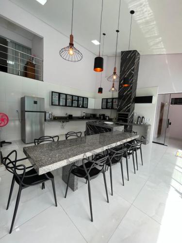 a large kitchen with a large table and chairs at Casa maria Júlia in Araguaína