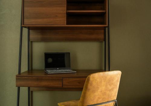 a laptop computer sitting on a desk with a chair at SOCRATES By Mr W in Mexico City